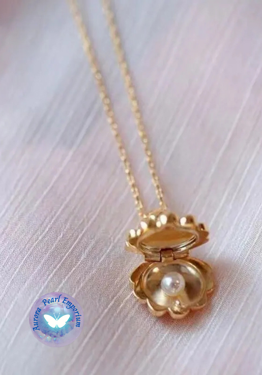 a gold necklace with a pearl inside